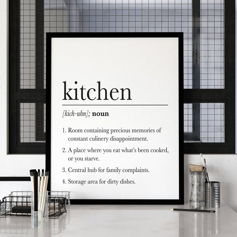 May include: A black and white printable wall art print with a humorous definition of the word "kitchen". The definition reads: "Room containing precious memories of constant culinary disappointment. A place where you eat what's been cooked, or you starve. Central hub for family complaints. Storage area for dirty dishes."