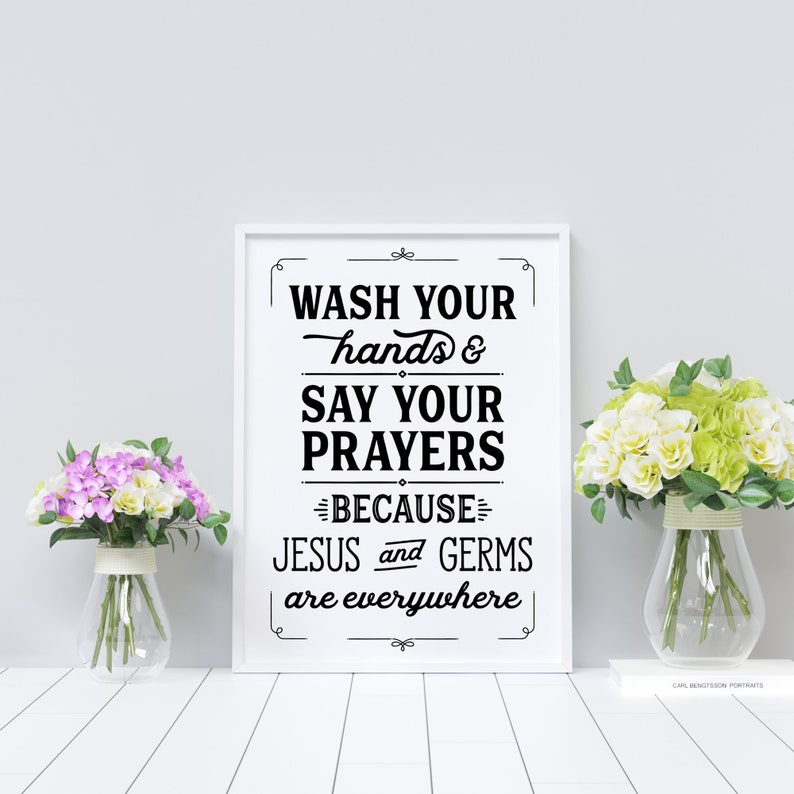 May include: A white framed print with black text that reads "Wash your hands & say your prayers because Jesus and germs are everywhere".