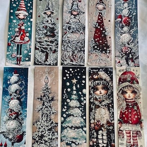 May include: A collection of ten rectangular bookmarks featuring vertical illustrations of stylized figures and Christmas trees. The designs incorporate red, white, and dark blue color palettes with glittery, textured snow effects and festive holiday motifs.
