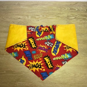 May include: A red bandana with yellow trim and a comic book print featuring words like "POW!" and "WHAMM!"