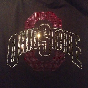 May include: A black t-shirt with a red and silver rhinestone design of the word "Ohio State".