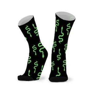 May include: A pair of black socks with a green snake pattern. The socks are made of a soft, comfortable material and are ideal for everyday wear.