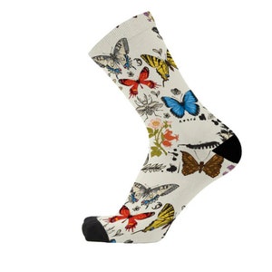 May include: A pair of white socks with a colorful butterfly pattern. The socks feature a variety of butterflies in different colors and sizes, including blue, red, yellow, and brown. The socks are made of a soft, comfortable material and are perfect for everyday wear.