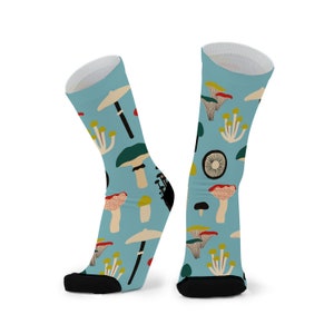 May include: A pair of blue socks with a colorful mushroom pattern. The socks have a black toe and heel.