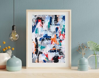 May include: Abstract art print in a light wood frame. The artwork features a vibrant mix of colours, including blue, orange, red, and white, with black accents. The painting has a textured appearance with visible brushstrokes and splatters.