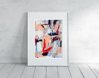 May include: Abstract art print in a white frame. The artwork features a colourful composition of brushstrokes in red, blue, peach, and white. The framed art is displayed against a white wall and wooden floor.