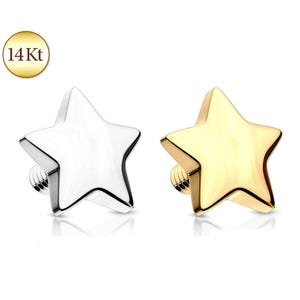 May include: Two star-shaped body jewelry pieces, one in a polished silver tone and one in a polished gold tone. Each star features a threaded post on the back. A circular gold badge in the upper left corner displays the text 14 Kt.