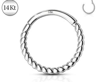 May include: A silver-colored, hinged nose ring with a twisted rope design. The ring is marked with "14Kt" and "14K". A smaller, open ring with the same design is also visible.