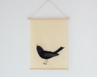 Felted and embroidered banner: the blackbird