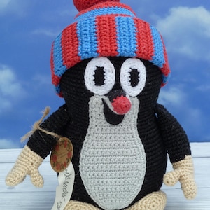 Crochet mole, amigurumi mole, the toy is crocheted, a mole in a hat