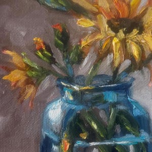 May include: A still life painting of sunflowers in a blue glass vase. The sunflowers have yellow and orange petals and green stems. The vase is a vibrant blue color, and the background is a muted gray.