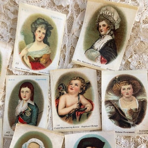 May include: A collection of vintage cigarette cards featuring portraits of historical figures and artwork. The cards are printed on paper with a cream background and oval-shaped images. The text on the cards includes the names of the subjects, artists, and dates.