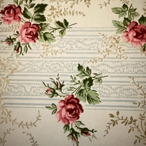 May include: A vintage wallpaper design with a repeating pattern of pink roses and green leaves on a cream background. The wallpaper has a subtle striped pattern.