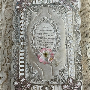 May include: A vintage Valentine's Day card with a lace design and a pink flower. The card features the text "LOVE" and a poem about love.