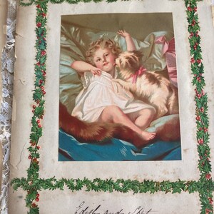 May include: An antique Christmas card featuring a young girl in a white dress with a dog. The image is framed with a green holly border and the text "Edith and Spot" is written in cursive at the bottom.