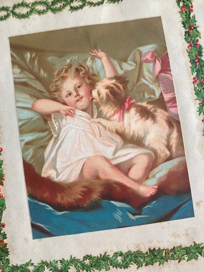 May include: A vintage illustration of a young girl lying in bed with a small dog. The girl is wearing a white dress and the dog is wearing a pink ribbon. The illustration is in a soft, pastel color palette.