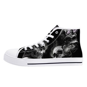 May include: Black and white high-top canvas shoes with a skull and smoke design.