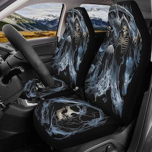 May include: A pair of black car seat covers with a graphic of a skeletal figure in a hooded robe surrounded by blue smoke. The figure is holding a scythe in one hand and a skull in the other.