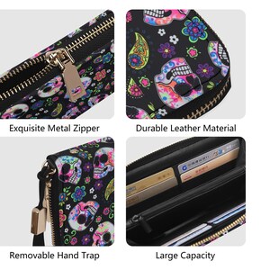 May include: A black zippered wallet with a colorful skull and floral print. The wallet has a removable hand strap and a large capacity for cards and cash.