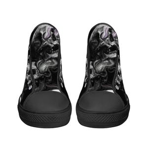 May include: Black high-top canvas shoes with a skull and smoke design. The skull is white with a purple glow in the eye sockets.