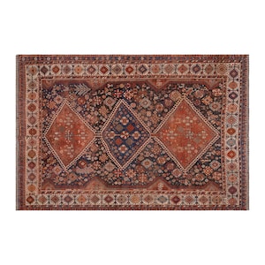 May include: Rectangular, antique rug with a detailed geometric pattern. The rug features a central design of three diamond shapes in shades of rust and navy blue, surrounded by a border of repeating motifs in red, cream, and brown.
