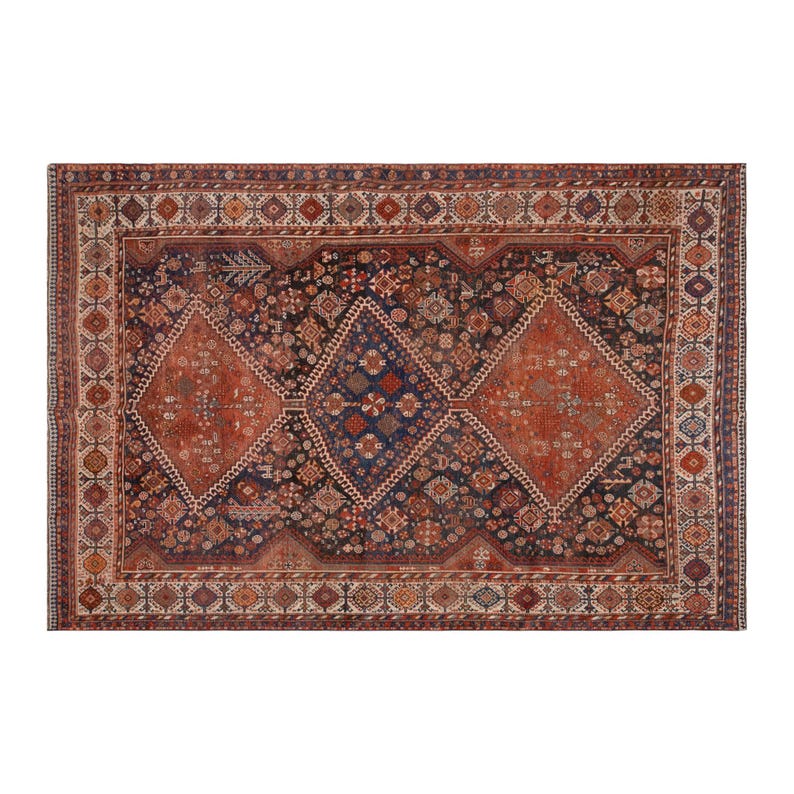 May include: Rectangular, antique rug with a detailed geometric pattern. The rug features a central design of three diamond shapes in shades of rust and navy blue, surrounded by a border of repeating motifs in red, cream, and brown.