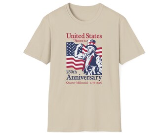 May include: A beige t-shirt with a graphic celebrating the 250th Anniversary of the United States. The design includes Uncle Sam, the American flag, and the text "United States of America" and "Quarter Millennial 1776-2026."