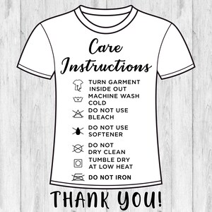 May include: A white t-shirt with black care instructions printed on it. The instructions include turning the garment inside out, machine washing cold, not using bleach or softener, not dry cleaning, tumble drying at low heat, and not ironing. The text "Thank You!" is printed below the instructions.
