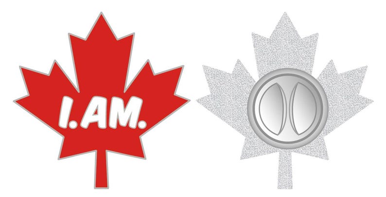 May include: A red maple leaf pin with the words "I AM." printed in white. The back of the pin shows a silver metal clasp.