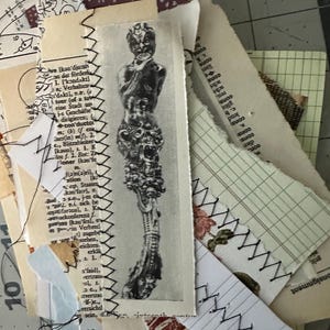 May include: A collage of paper scraps with a black and white image of a creature with a human-like body and a head with horns. The image is surrounded by scraps of paper with text and stitching.