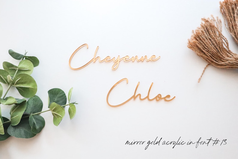 Może przedstawiać: Dwa złote imiona z akrylu lustrzanego, "Cheyenne" i "Chloe", w czcionce #13.