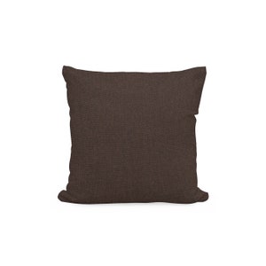 以下が含まれることがあります： テクスチャのある生地の茶色の正方形のクッション