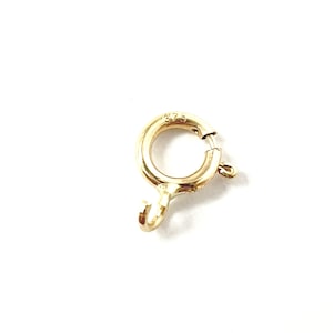 May include: Gold-toned metal clasp with a spring-loaded ring and a hook. The clasp is marked "375".