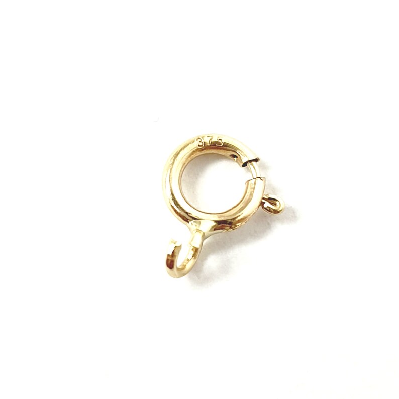 May include: Gold-toned metal clasp with a spring-loaded ring and a hook. The clasp is marked "375".