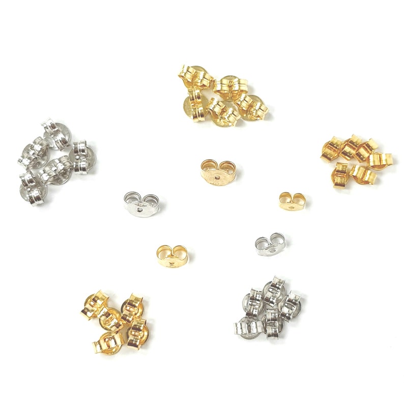 May include: Assortment of gold and silver earring backs. The backs are made of metal and have a butterfly closure.