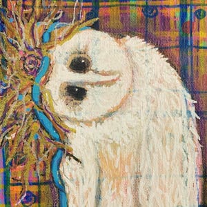 May include: A white owl with a crown of gold and blue branches on a colorful plaid background.