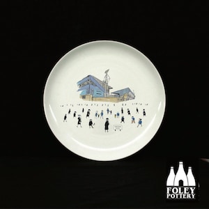 May include: White ceramic plate with a black and white illustration of a stadium and people walking towards it. The text "FOR SALE NOW" is printed on a sign in the illustration.
