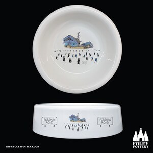 May include: White ceramic dog bowl with a black and white illustration of a stadium and the text "Portman Road" on the side.