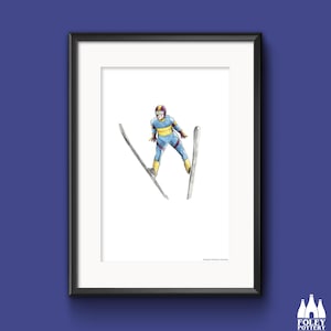 May include: A framed illustration of a skier in mid-air, wearing a blue and yellow ski suit with a maroon helmet, against a white background. The skier is holding two skis, one in each hand, with the tips of the skis pointing towards the ground.