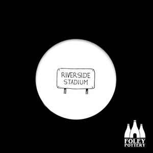 May include: A white ceramic coaster with a black and white illustration of a road sign that reads "RIVERSIDE STADIUM". The coaster has a black background and the Foley Pottery logo.