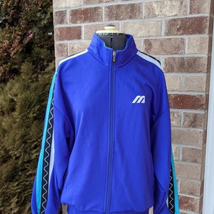 May include: A blue zip-up jacket with white and turquoise stripes on the sleeves. The jacket has a white "M" logo on the chest.