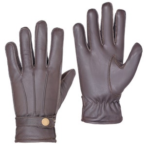May include: A pair of brown leather gloves with a button detail on the wrist.