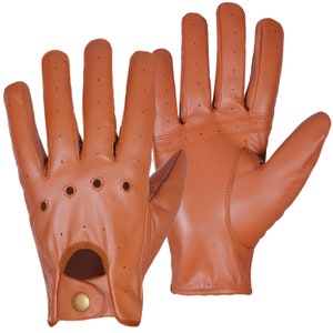 May include: A pair of brown leather driving gloves with perforated detailing. The gloves have a button closure on the wrist.