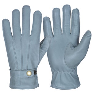 May include: A pair of gray leather gloves with a button closure on the wrist.