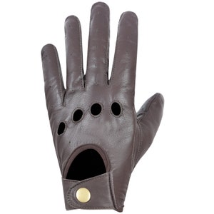 May include: Brown leather driving gloves with a perforated design and a button closure on the wrist.