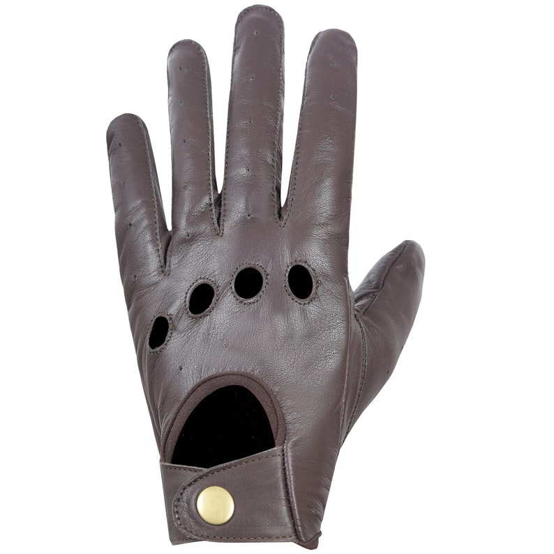May include: Brown leather driving gloves with a perforated design and a button closure on the wrist.