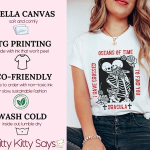 May include: White t-shirt with a black and white graphic print of two skeletons embracing. The text "I have crossed oceans of time to find you +Dracula+" is printed on the shirt.