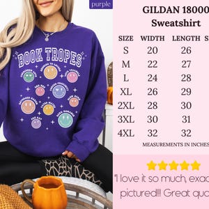 May include: A purple Gildan 18000 sweatshirt with the text "BOOK TROPES" and various smiley face graphics. The sweatshirt includes a size chart with measurements in inches. The text "Forbidden Love" and "Enemies to Lovers" are also visible.