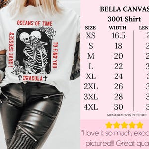 May include: White t-shirt with a black and white graphic of two skeletons embracing. The graphic is surrounded by red text that reads "I have crossed oceans of time to find you" and "Dracula". The shirt is available in sizes XS to 4XL with measurements in inches.