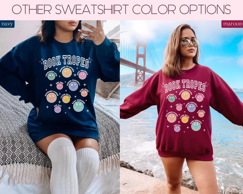 May include: Navy blue and maroon sweatshirts with the text "BOOK TROPES" and colorful smiley face graphics. The sweatshirts have a crew neck and long sleeves. The navy sweatshirt is paired with white knee-high socks.